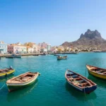 Baia de Mindelo em Sao Vicente com barcos coloridos e o Monte Cara ao fundo