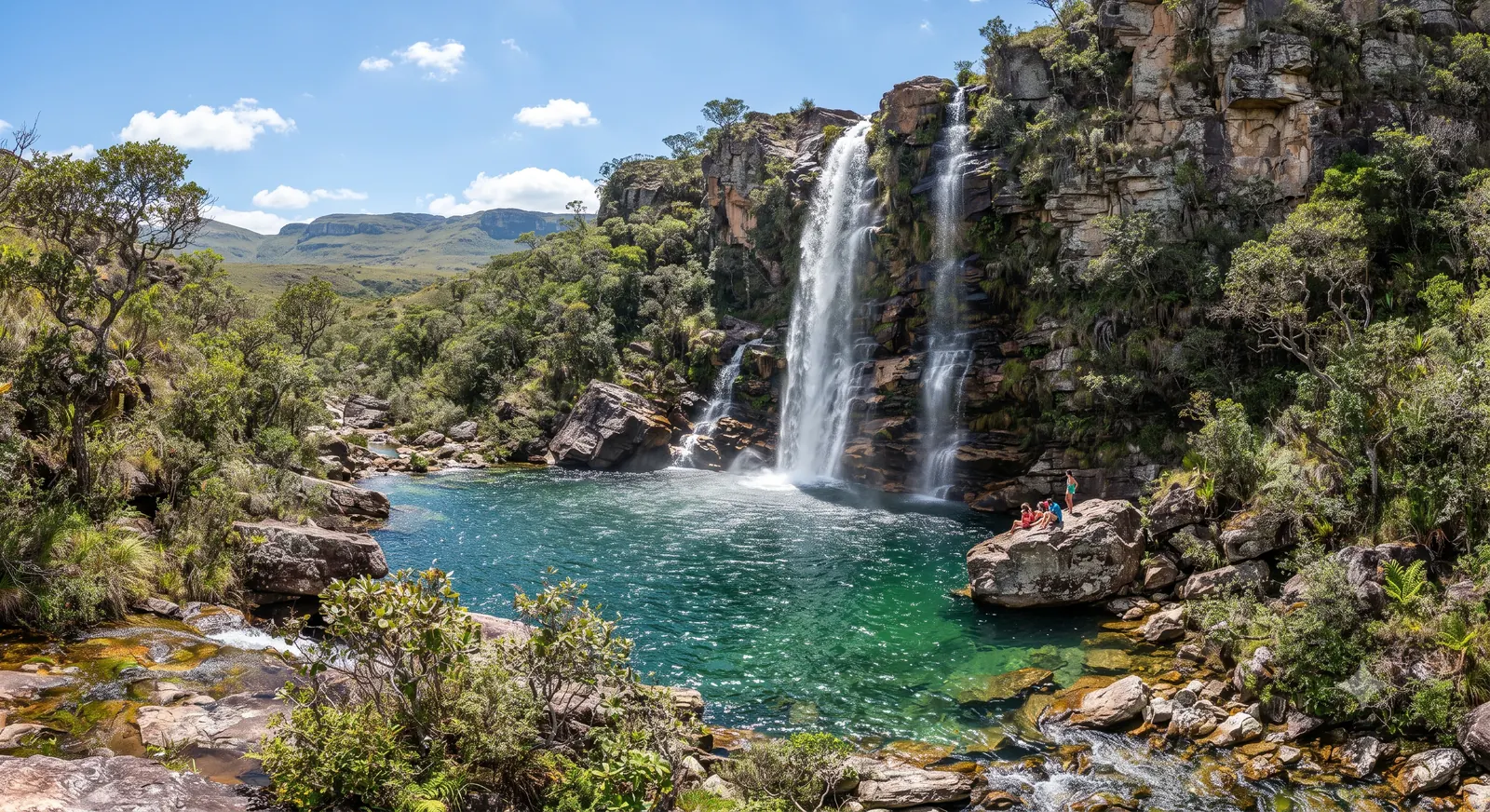 Cachoeira alta caindo em poco natural cercado por vegetacao de cerrado na Chapada dos Veadeiros